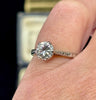 A classic 1950s six claw diamond ring set in platinum on the finger with intricate hand engraving