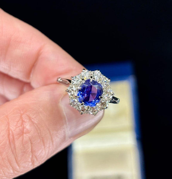 Close-up of a color change Ceylon sapphire cluster ring set with diamonds.