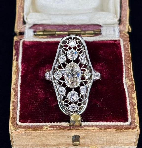 Antique Art Deco jewelry collectible featuring a diamond openwork ring with intricate designs.