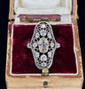 Antique Art Deco jewelry collectible featuring a diamond openwork ring with intricate designs.