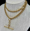 Edwardian gold Albert chain with a graduated curb link design, reflecting period artistry.