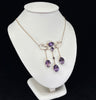Edwardian amethyst necklet crafted in 9ct yellow gold, showcasing oval suspended amethysts and half pearls, part of Australian jewellery.