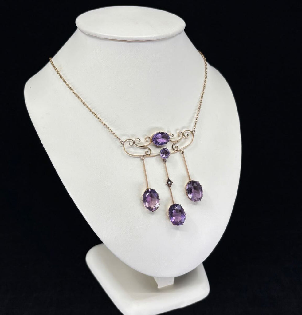 Edwardian amethyst necklet crafted in 9ct yellow gold, showcasing oval suspended amethysts and half pearls, part of Australian jewellery.