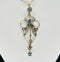 Close up view of the beautiful blue aquamarine stones in the edwardian aquamarine and pearl pendant