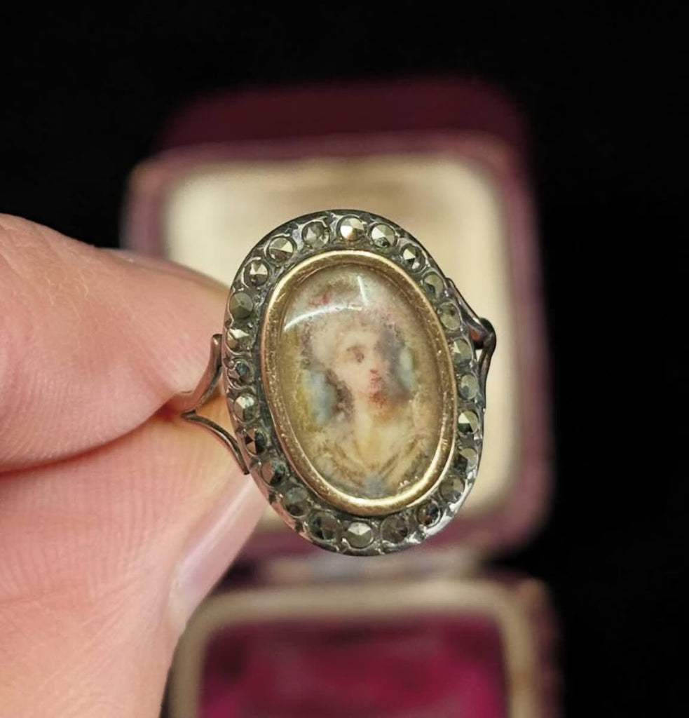 Beautifully crafted Georgian ring with a miniature portrait and intricate detailing, symbolising love and remembrance from the 19th century.