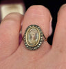Antique Georgian portrait ring featuring an elegant young woman, adorned with marcasite and set in rose gold, a true representation of historical craftsmanship.