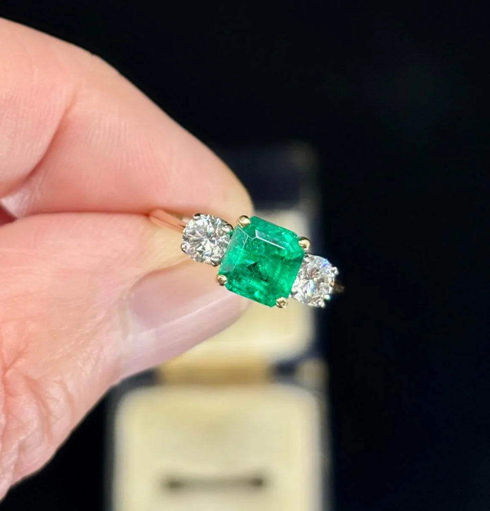 Handmade 1950s emerald and diamond engagement ring showcasing intricate craftsmanship.