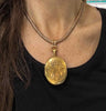 The large scale of the antique 18ct yellow gold locket worn on a collar to show its impressive design
