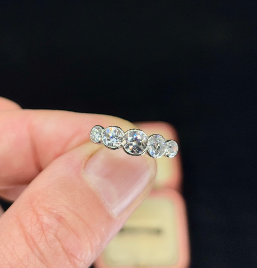 Elegant platinum half hoop ring featuring graduated old European cut diamonds.