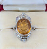 A close up photo of the Rhoda Wager citrine and gumleaf surround, with fine shoulders to a fine silver band