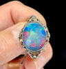 Signed Rhoda Wager opal doublet brooch framed in gold and silver, emphasising intricate detailing.