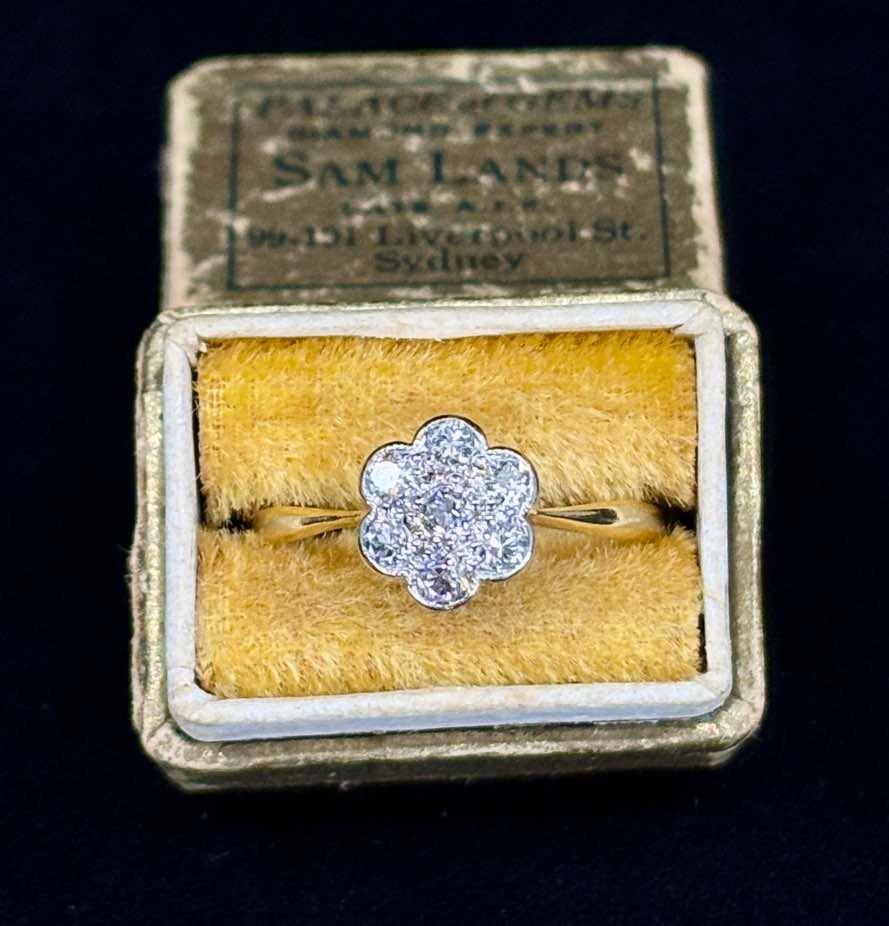 Timeless daisy cluster engagement ring made with antique diamonds, highlighting a classic design and elegant craftsmanship.