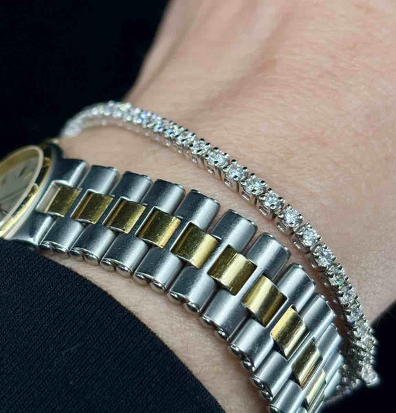 Timeless diamond line bracelet with 65 brilliant cut stones set in white gold.