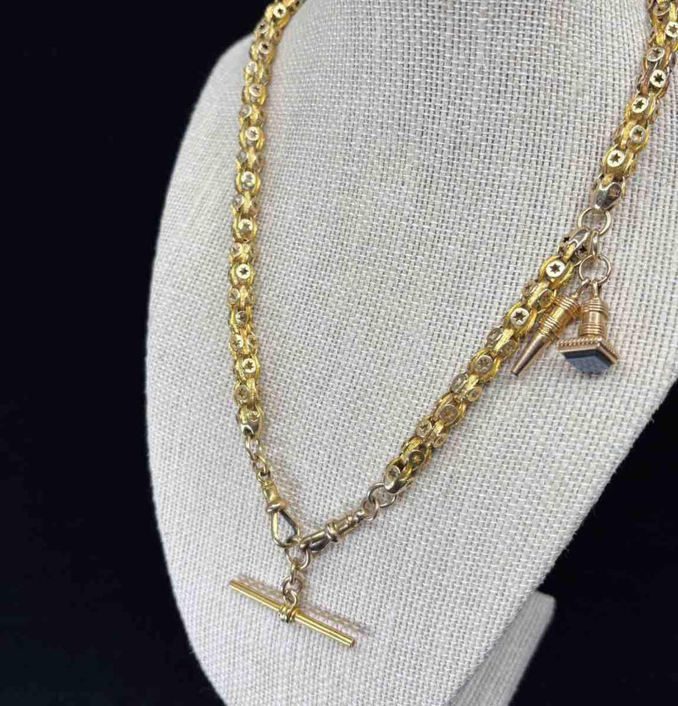 Victorian T-Bar chain with fancy star link pattern in yellow gold.