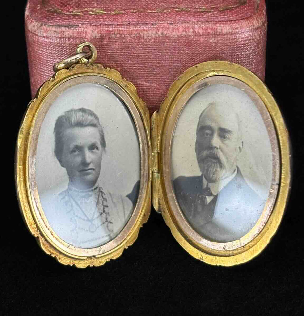 Open antique Victorian gold locket displaying portraits of a Victorian man and woman, wearing the locket featured.