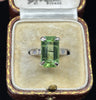 green emerald cut peridot ring four claw set in an antique ring box