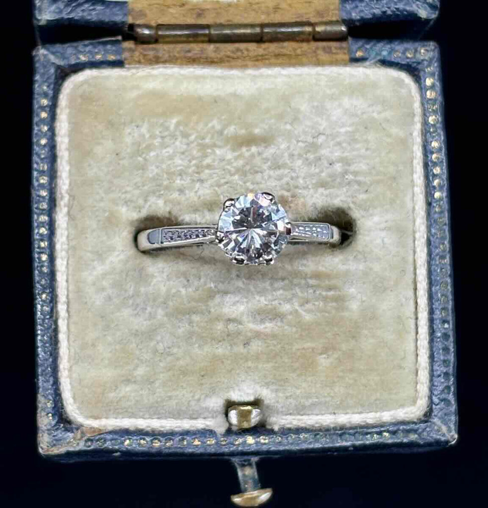 Vintage 1950s brilliant cut diamond solitaire engagement ring in a royal blue antique ring box