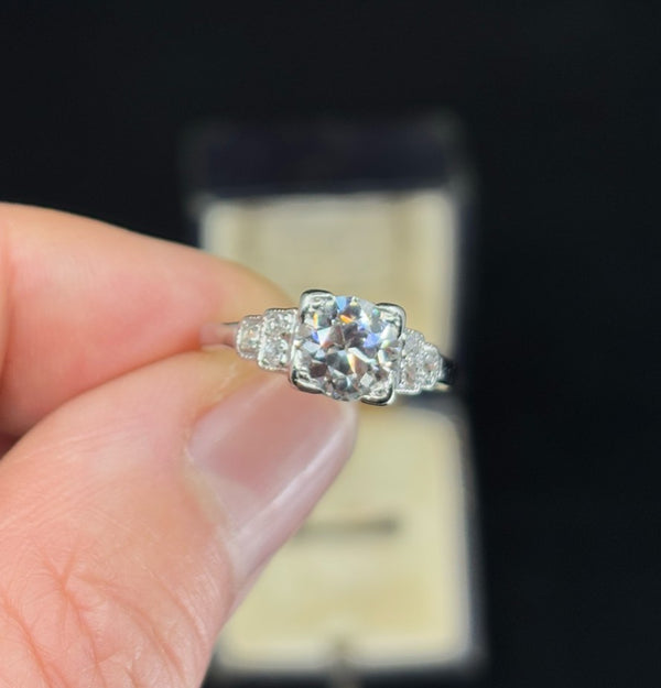 Close-up of a 1920s vintage Art Deco engagement ring featuring an Old European cut diamond in a platinum setting.