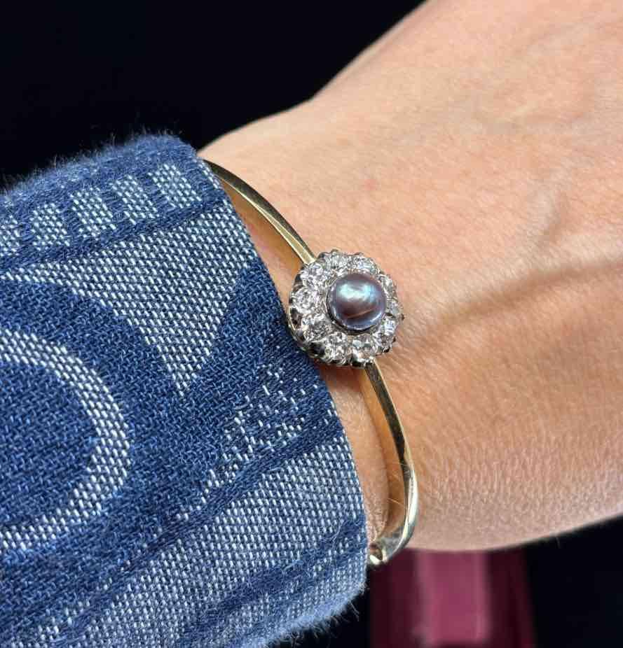  Vintage Austro-Hungarian bangle with a unique design, featuring a black pearl and sparkling old cut diamonds.