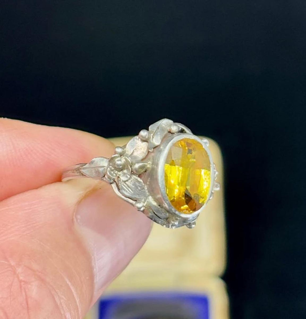 Vintage 1930s Rhoda Wager silver ring featuring a large citrine gemstone with intricate floral details.