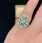 Vintage platinum engagement ring showcasing a central diamond with baguette cut emeralds and intricate design elements.