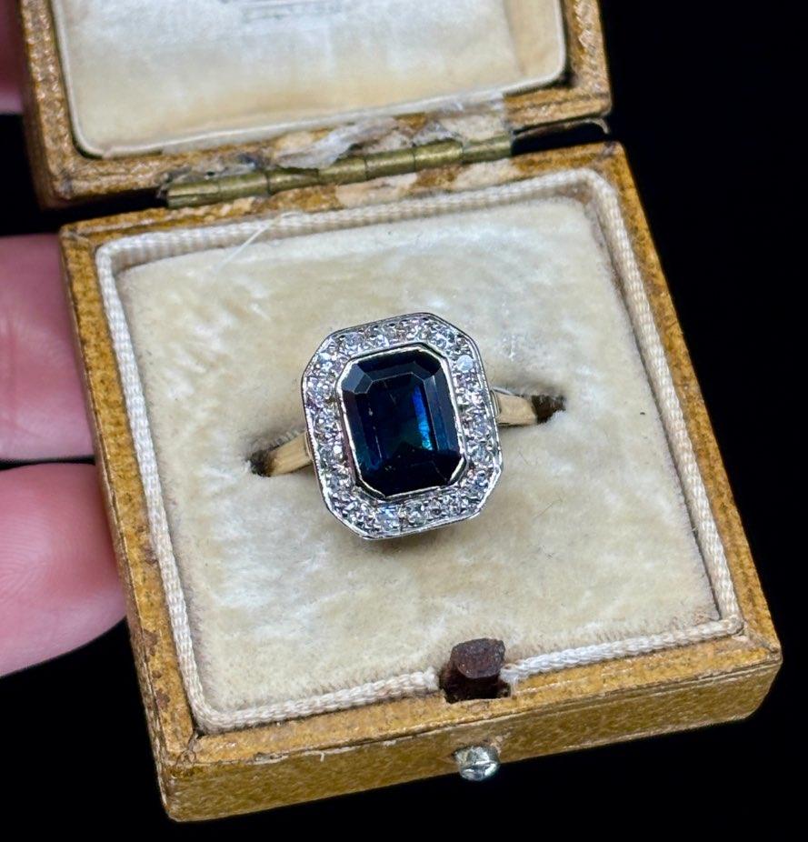 Vintage 1930s sapphire and diamond ring showcasing Art Deco influences with geometric design elements.