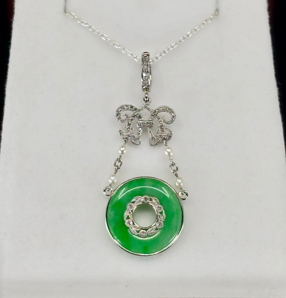 A‑type jadeite pendant in platinum, untreated natural jadeite pi disc set with rose‑cut diamonds — circa 1900