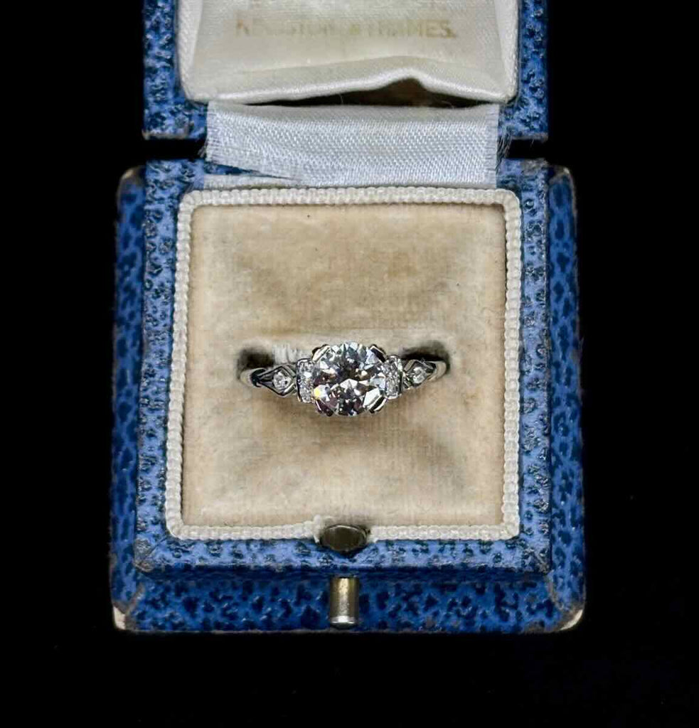 Angus and Coote 1940s diamond engagement ring set in 18ct white gold featured in vintage ring box.