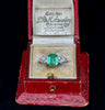 Antique 1930s three‑stone platinum ring with 1.15ct Colombian emerald emerald‑cut and two old European cut diamonds.
