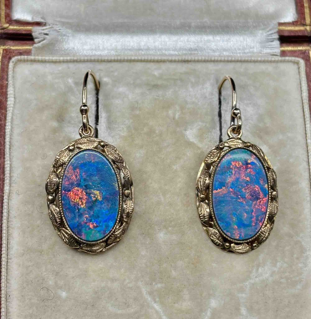 Pair of antique 1930s gold opal earrings with blue-dominant play of colour and red flashes