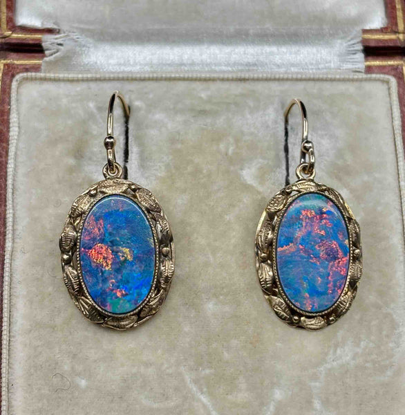 Pair of antique 1930s gold opal earrings with blue-dominant play of colour and red flashes