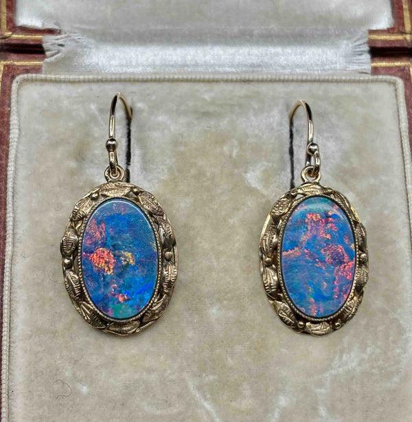 Pair of antique 1930s gold opal earrings with blue-dominant play of colour and red flashes