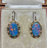 Pair of antique 1930s gold opal earrings with blue-dominant play of colour and red flashes