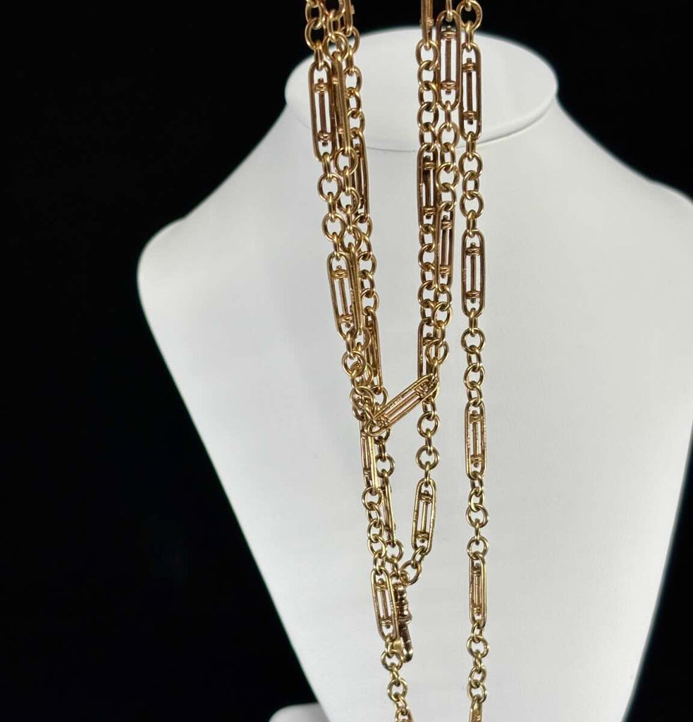 Antique 9ct gold guard chain featuring uncommon rectangular bar links and circular connectors, shown draped on a bust — perfect vintage accessory.