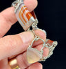 Close-up of an antique Scottish agate bracelet showcasing intricate sterling silver detailing and colourful stones.