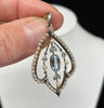 Antique Edwardian aquamarine and pearl pendant set in platinum and 15ct yellow gold, detailed foliate design and delicate pearl border.