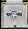Antique diamond ring featuring a black enamel border and cluster design.