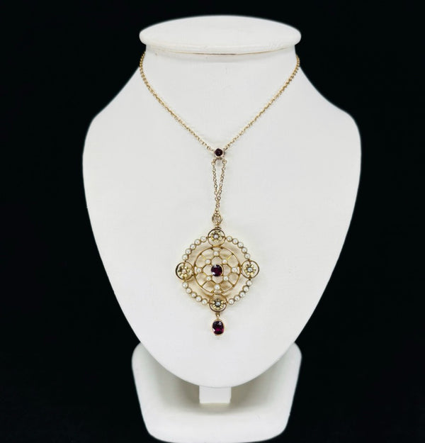 An Edwardian gold pendant necklace with intricate patterns and a sophisticated charm.