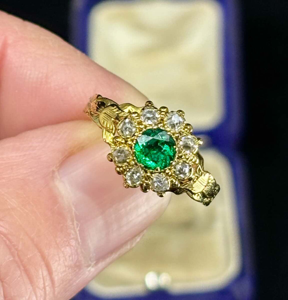 antique emerald and diamond ring in 18ct yellow gold with intricate engraving.