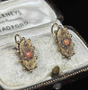 Antique gold coral earrings showing applied bead granulation around the shield frame