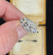 Vintage Art Deco diamond cluster ring in platinum, featuring twin old European cut diamonds and single cut diamonds.