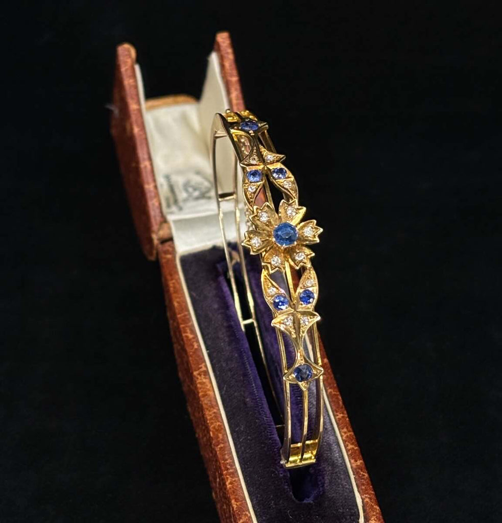 Antique gold bangle with sapphire flower motif, rare Australian bangle showcasing Victorian-era craftsmanship.