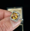 Antique imperial topaz gemstone ring set in a vintage design with diamond embellishments.