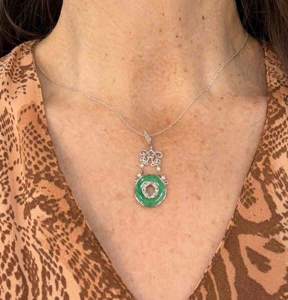 Antique jadeite pendant from the Belle Époque era, platinum mount surrounding a luminous A‑type jade pi disc