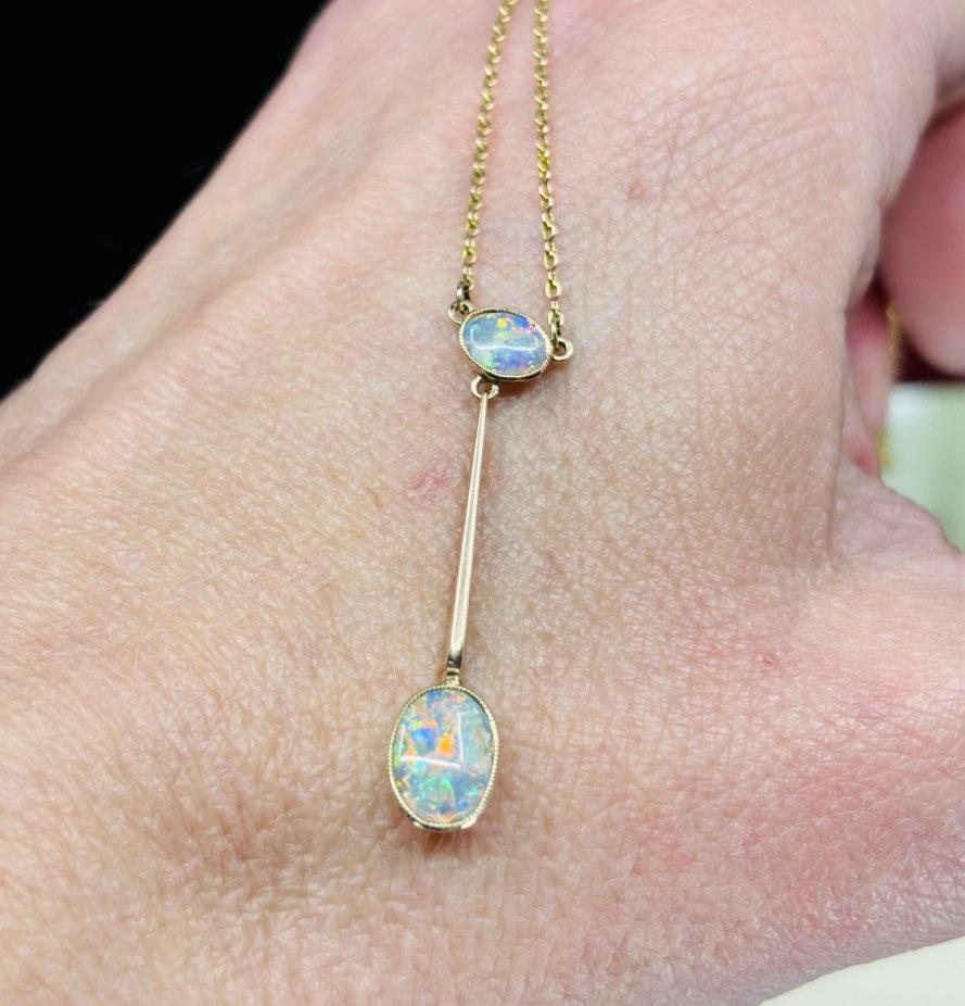 antique opal pendant necklace from the Edwardian era, showcasing a refined and elegant oval pendant drop set in fine 9ct yellpw gold