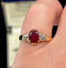 Antique Edwardian 1905 three‑stone ring with 2.53ct oval ruby and two old‑European cut diamonds (0.46ct) in 9ct yellow gold — claw set, vintage engagement ring.