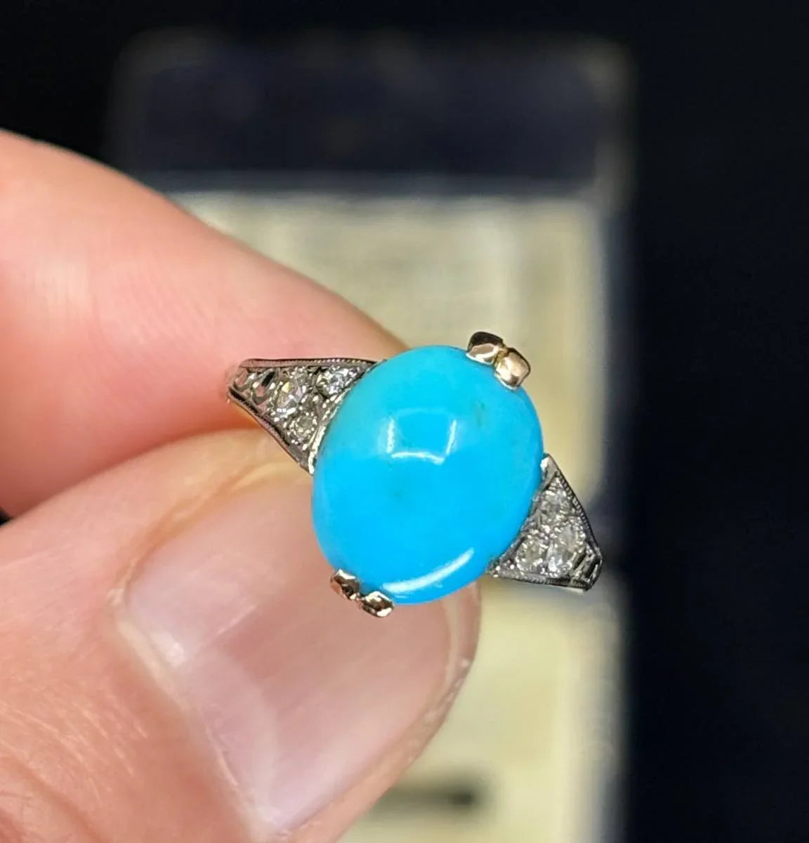Antique turquoise ring from 1925, highlighting the smooth oval turquoise stone complemented by six single-cut diamonds set in the band.