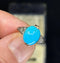 Antique turquoise ring from 1925, highlighting the smooth oval turquoise stone complemented by six single-cut diamonds set in the band.