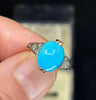 Antique turquoise ring from 1925, highlighting the smooth oval turquoise stone complemented by six single-cut diamonds set in the band.