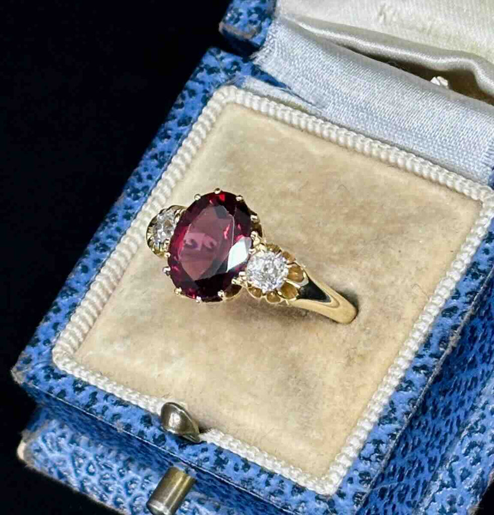 Antique oval 3ct garnet and diamond ring showcasing the side of the setting.
